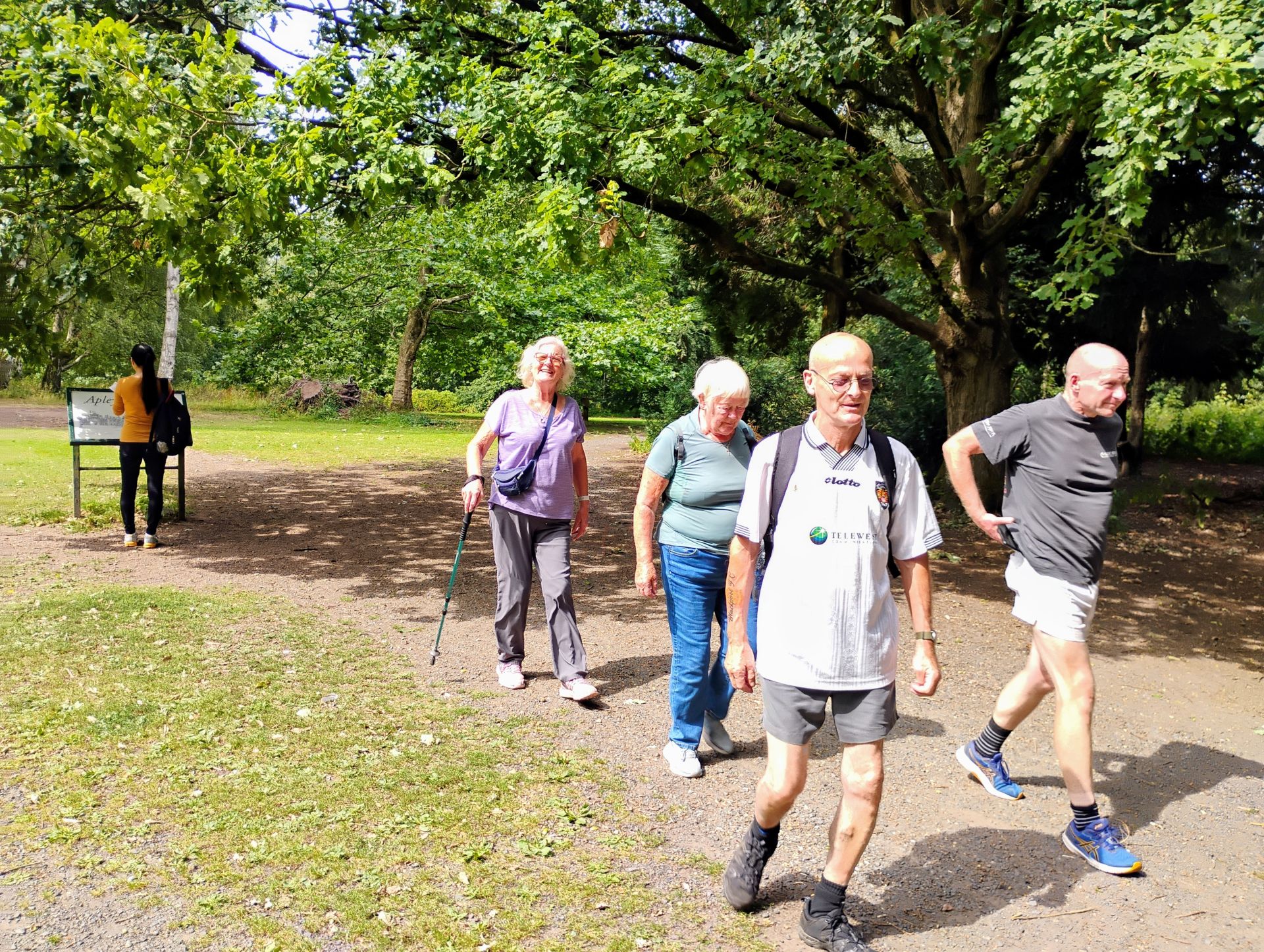 Diverse group of walkers chatting on a Wellington park path